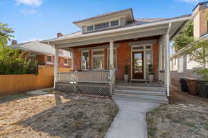 Bungalow-style home featuring a porch and brick siding