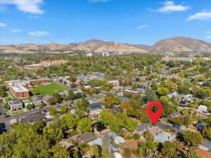 Aerial view of property and surrounding area with nearby suburban area