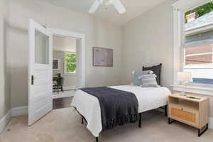 Bedroom with a ceiling fan and carpet floors