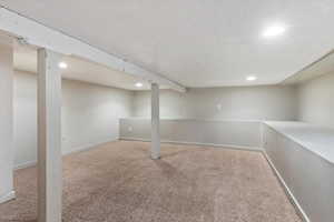Finished below grade area with recessed lighting and carpet