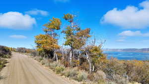 View of dirt / gravel road featuring a water view