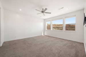 Empty room with light colored carpet, recessed lighting, and ceiling fan