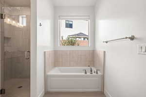Bathroom with a garden tub and a shower stall