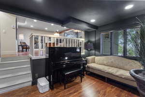 Living area with wood finished floors, recessed lighting, and plenty of natural light