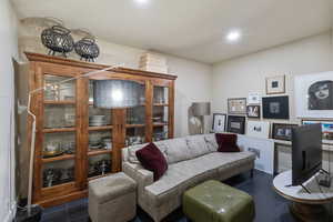 Living area featuring dark tile patterned floors and recessed lighting