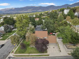 Aerial view of property's location featuring a mountainous background and nearby suburban area