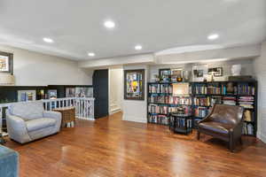 Sitting room featuring wood finished floors, recessed lighting, and stairs
