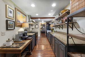 Kitchen with open shelves, dark wood finished floors, recessed lighting, light stone countertops, and gas stove