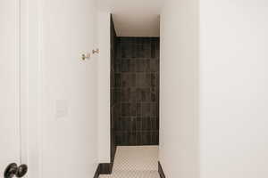 Walk-in Contemporary Shower with tile patterned flooring