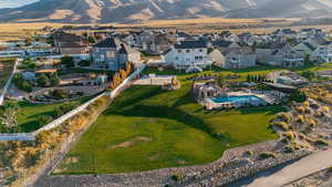 Aerial perspective of suburban area featuring Baseball Diamond, Basketball Court, Pool & mountains