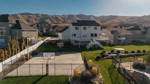 Surrounding community featuring a mountain view, a residential view, basketball court, a patio area, and stairs