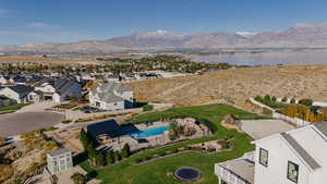 Aerial view of residential area with a pool area and a water and mountain view