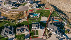 Aerial view of residential area with property parcel outlined .  BASEBALL DIAMOND,  BASKETBALL COURT and a POOL area w covered OUTDOOR KITCHEN!