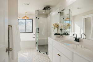 Full bath featuring vanity, large walk-in shower w Euro glass, a garden tub, and light tile patterned floors
