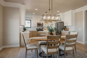 Dining area featuring crown molding, light wood-style floors, recessed lighting and a lot of daylight
