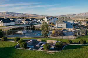 Aerial view of residential area featuring a firepit and a mountain backdrop