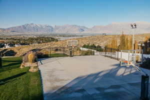 View of basketball court featuring a mountain view.  Pickleball Net Included!