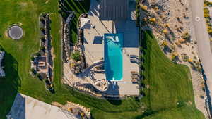 Drone / aerial view of a pool, Firepit and Basketball court