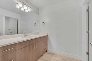 Bathroom featuring vanity and light wood finished floors
