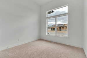 Carpeted empty room with baseboards