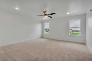 Spare room featuring light carpet, a ceiling fan, and recessed lighting