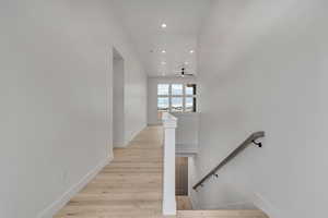 Staircase featuring recessed lighting and wood finished floors
