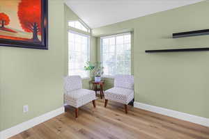 Living area featuring lofted ceiling and wood finished floors
