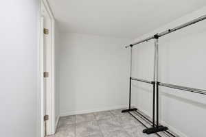 Spacious closet with light tile patterned floors