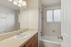 Full bath featuring vanity and shower / tub combination