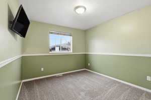 Unfurnished room with carpet flooring and baseboards