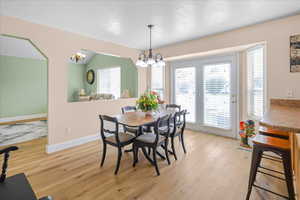 Dining area with light wood-style floors and baseboards