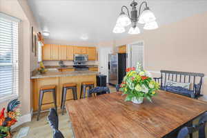 Dining room featuring light wood-style floors and a chandelier