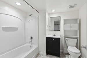 Bathroom with vanity, shower / bathtub combination, light tile patterned floors, and recessed lighting