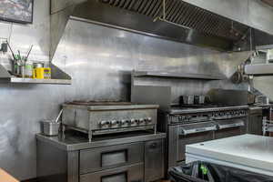 Kitchen with ventilation hood and stainless steel countertops