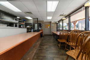 Dining area featuring a paneled ceiling and dark wood finished floors