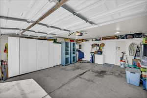 Garage featuring electric panel and a garage door opener