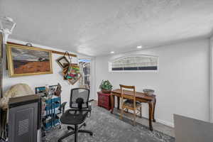 Office area featuring a textured ceiling and baseboards