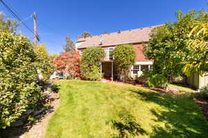 View of green lawn with a patio area