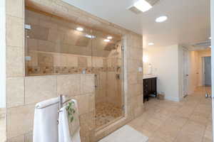 Full bath with vanity, recessed lighting, a shower stall, and light tile patterned floors