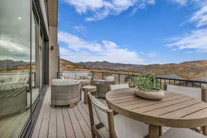 Balcony featuring a mountain view and an outdoor hangout area
