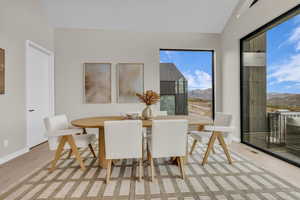 Dining space featuring a mountain view and vaulted ceiling