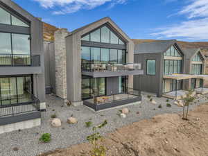 Back of house featuring a balcony and a patio