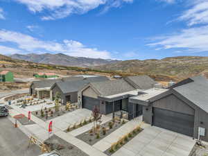 View of front of home featuring an attached garage, a mountain view, and concrete driveway