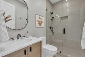 Bathroom featuring a shower stall and vanity