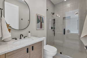 Bathroom featuring vanity and a shower stall