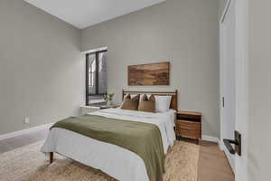 Bedroom featuring light wood-type flooring and baseboards