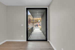 Entryway with wood finished floors and floor to ceiling windows