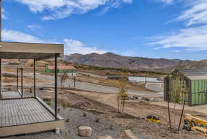 View of yard featuring a mountain view and an outbuilding