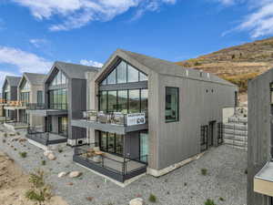 Rear view of property with a balcony and a patio area