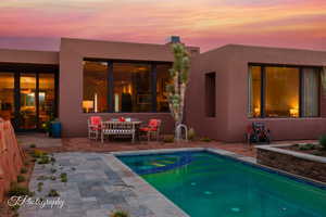 View of swimming pool with a patio and a pool with connected hot tub